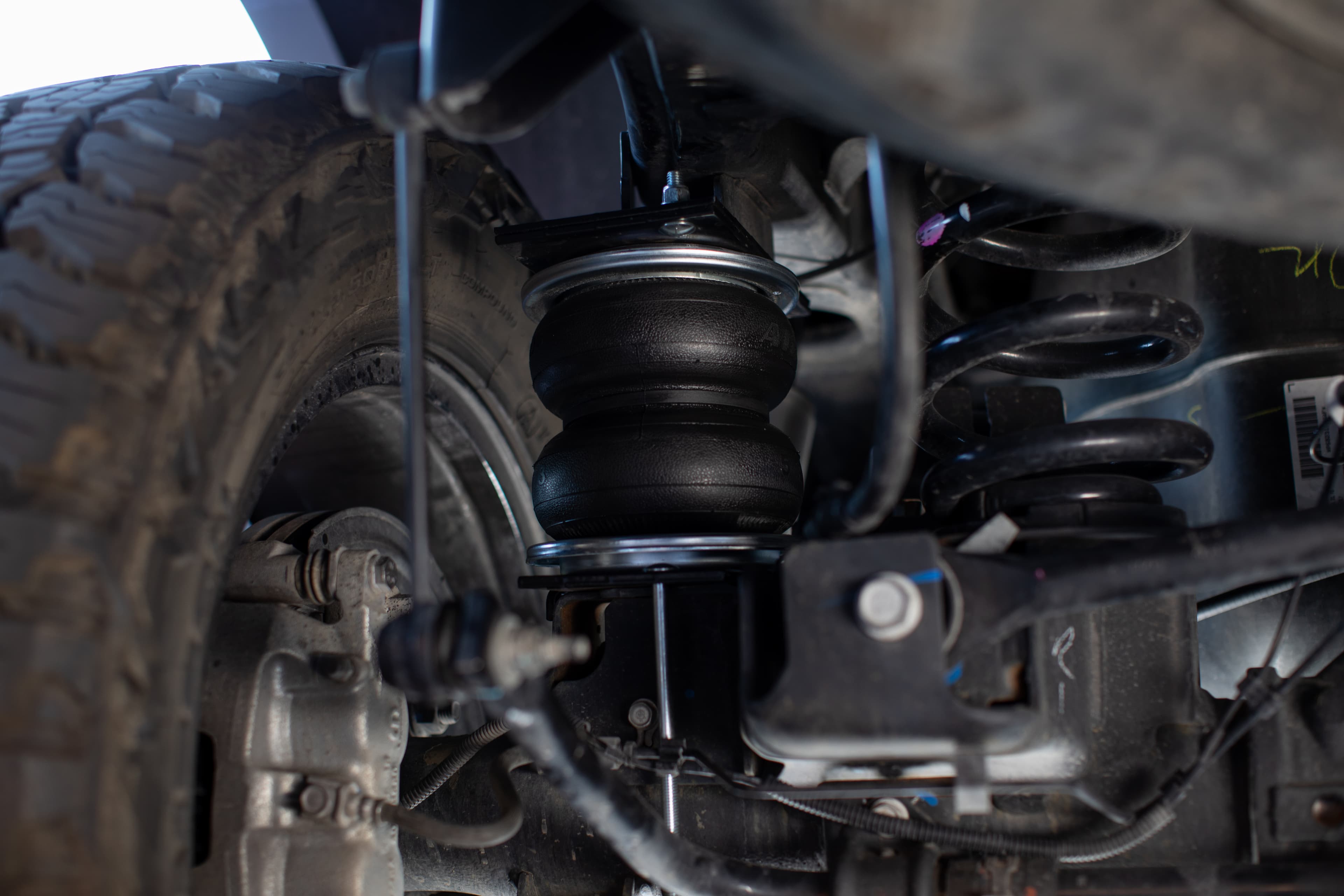 Air Lift air spring mounted under a vehicle